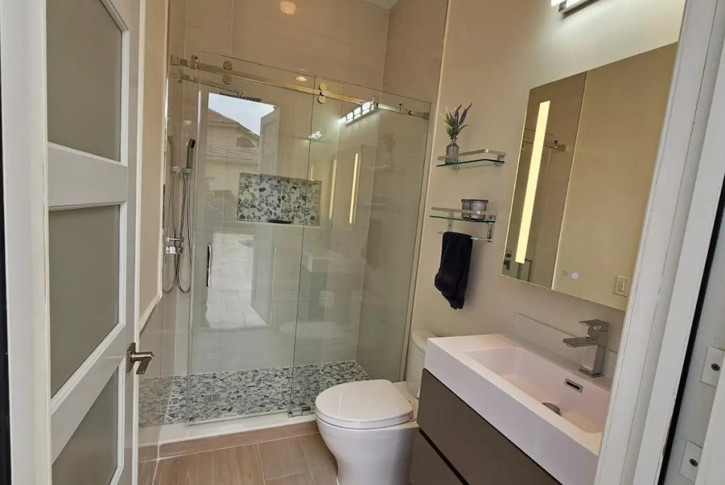 Bathroom remodel with glass shower and modern vanity in a Boynton Beach home